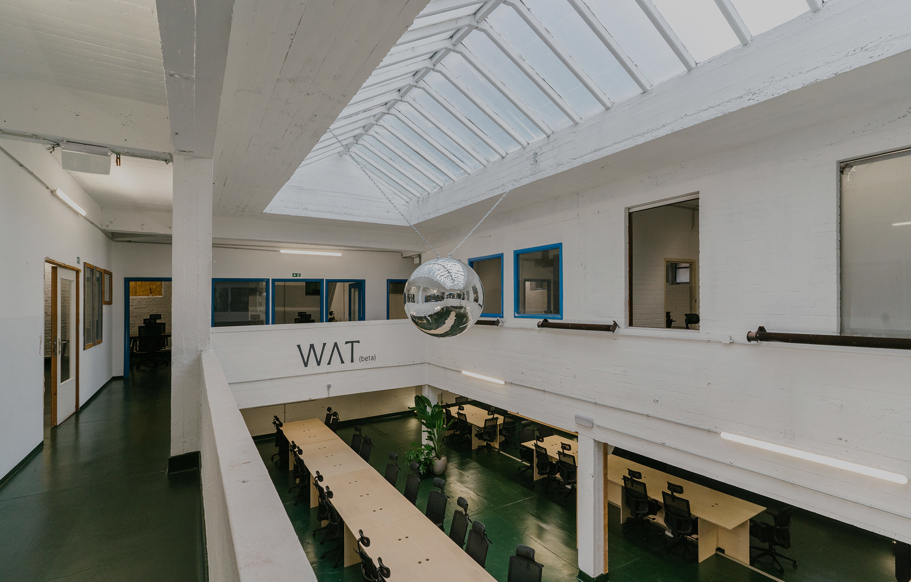 The WAT venue interior, with tables prepared for a gathering.